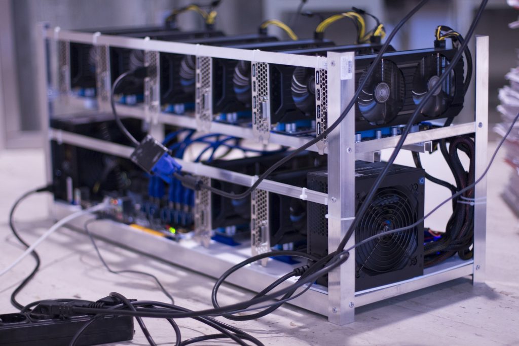 a photo of an actual bitcoin mining rig, with lots of graphic processors attached to each other.
