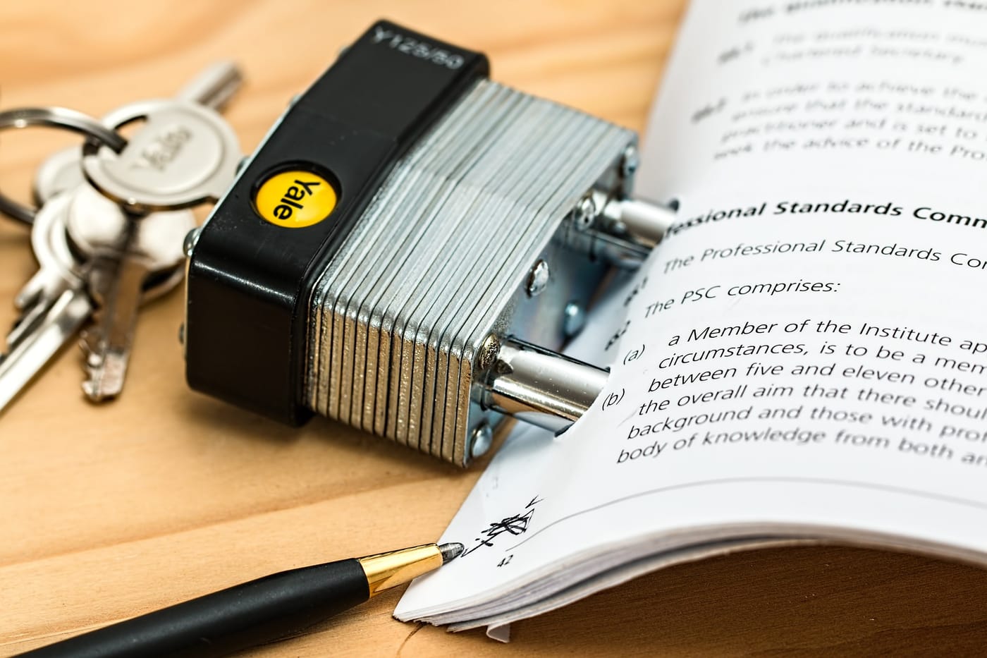 this photo represents a contract with a steel lock inserted through the paper