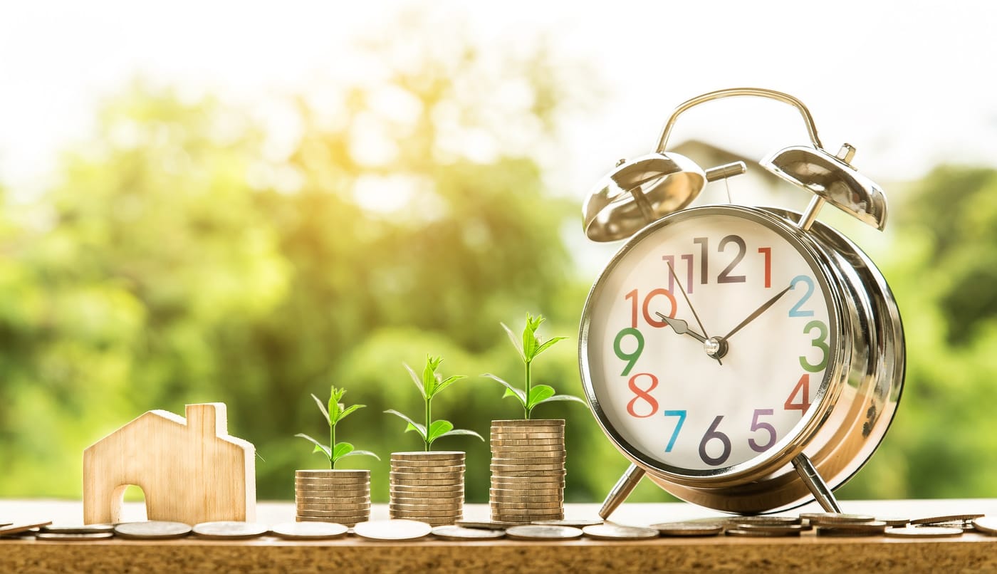 ico investment represented by coins growing with a little plant and a clock